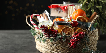 Wicker,Basket,With,Gift,Set,And,Christmas,Decor,On,Grey